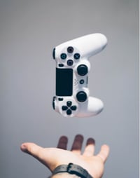 Image with hand on PS4 Control